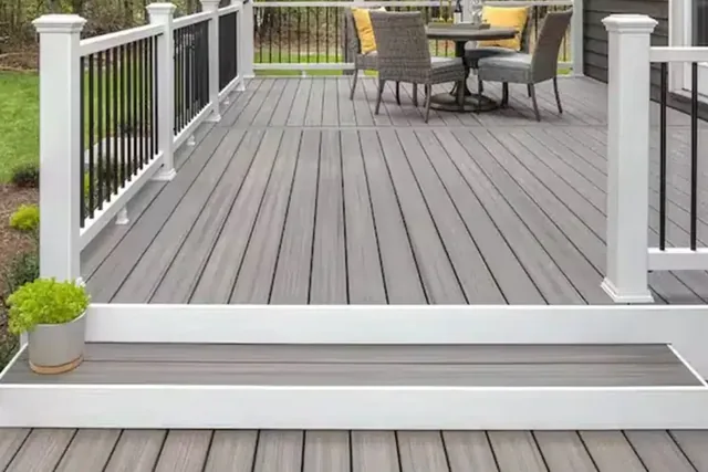 Gray composite deck with white posts and black balusters