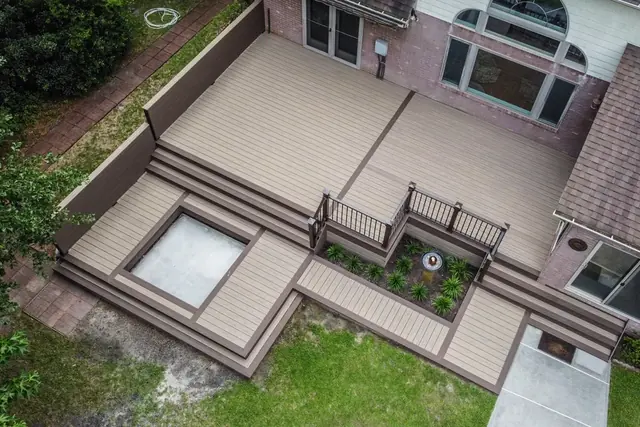 Aerial view of a multi-level two-tone composite deck with built-in planters