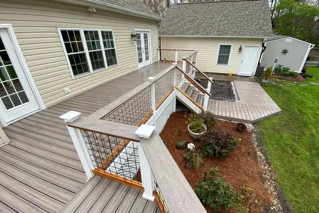 Multi-level composite deck with wood-capped wire panel railing